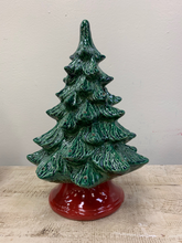 Load image into Gallery viewer, Hand Painted Medium Christmas Tree stands 12&quot; high, but on the base it measures 14&quot; high.  It has a green lustre glaze and red base!  It comes with multi-color pin lights, orange star and a clip-in light kit (7 watt bulb).    Includes free curbside pickup or free shipping.
